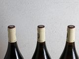 three bottles of wine sitting on a table next to each other