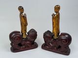 pair of asian figurines of a man and a woman on a horse