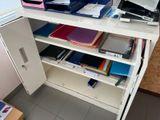 a white desk with a bunch of files on it