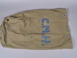 an old brown bag with blue writing on it sitting on a white surface