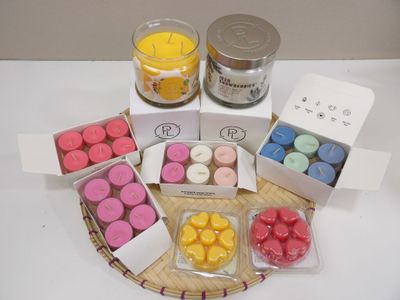 many candles that are sitting on a tray on the table