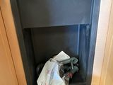 a box that has a bag in it in the corner of a room