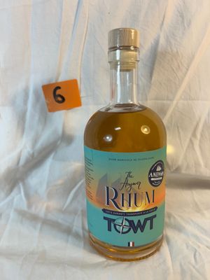 a bottle of rum that is sitting on a white sheet