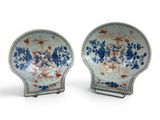 pair of blue and white plates with flowers on them on a stand