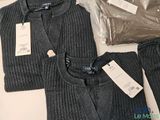 a picture of a pair of sweaters and pants sitting on a table