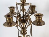 a large brass candelab with a blue vase on it