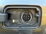 a close up of a car ' s charging station with a yellow car in the background