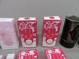 three boxes of perfumes and a can of tea on a table