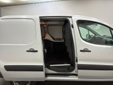 a white van with its doors open in a garage
