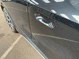 a close up of a car door handle with a sticker on it