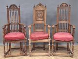 three wooden chairs with red cushions sit on a wooden floor