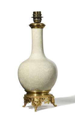 a white and gold vase on a stand on a white background