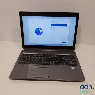 an open laptop computer sitting on top of a white table