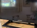 the sony flat screen tv is sitting on the counter in front of a window