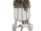 a white sled with a brown fur on top of it