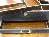two open suitcases sitting on a wooden table