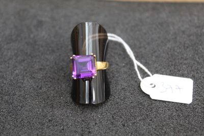 a ring with a purple stone on it and a price tag