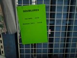 a green sign on a metal rack in a room