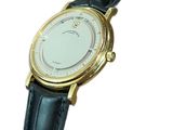 a gold wrist watch with a white dial on a black leather strap