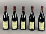 six bottles of wine lined up in a row on a table