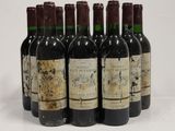 six bottles of wine are lined up in a row on a white surface