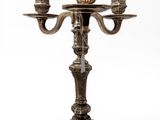 a metal candelab with three candles on it