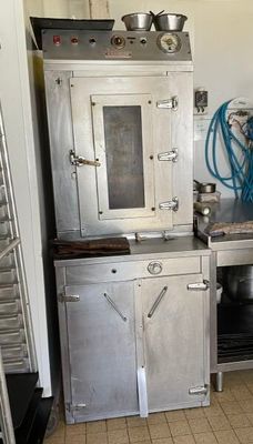 a kitchen with a stove, sink, and oven in it