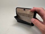 a person holding an empty wallet on a table