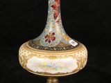 a vase that is sitting on a stand on a black background