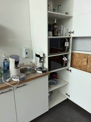 a small kitchen with a microwave and a sink in it