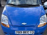 a blue car that is parked in a parking lot