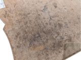a dirty carpet with a tag on it