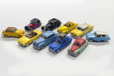 several toy cars are lined up in a row on a white surface