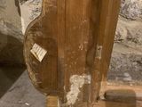 a wooden door with a sticker on it in the corner of a room