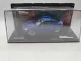 a blue toy car in a clear box on a white surface
