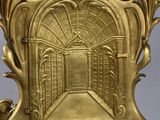 an image of a gold clock with a clock face on top of it