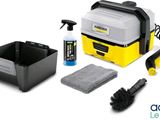 a close up of a yellow and black cleaning kit on a white background