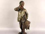 bronze statue of a man talking on a cell phone and holding a briefcase