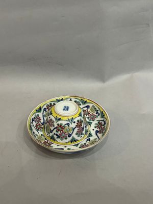 a small plate with a yellow and blue design on it