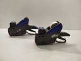pair of black and blue tape dispensers on a white surface
