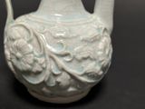 a blue and white vase on a black table