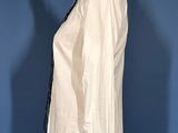 an image of a mannequin wearing a white shirt and black pants