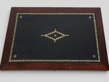 a wooden box with a black and gold design on it