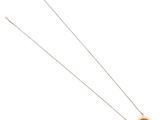 a close up of a necklace on a white surface with a chain