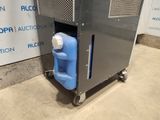 an image of a machine with a blue container on wheels