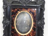an old picture frame with a picture of a man in a suit