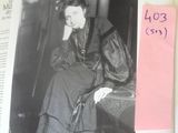 a black and white photo of a woman sitting on a chair