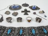 a lot of silver and blue jewelry on a white table