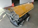 a yellow fan sitting on top of a cart in a garage