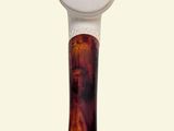 a picture of a wooden spoon with a white handle